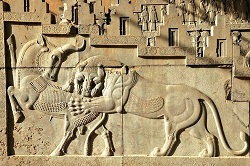 The bas-relief of a lion attacking a bull at Persepolis, dating back approximately 2,500 years.